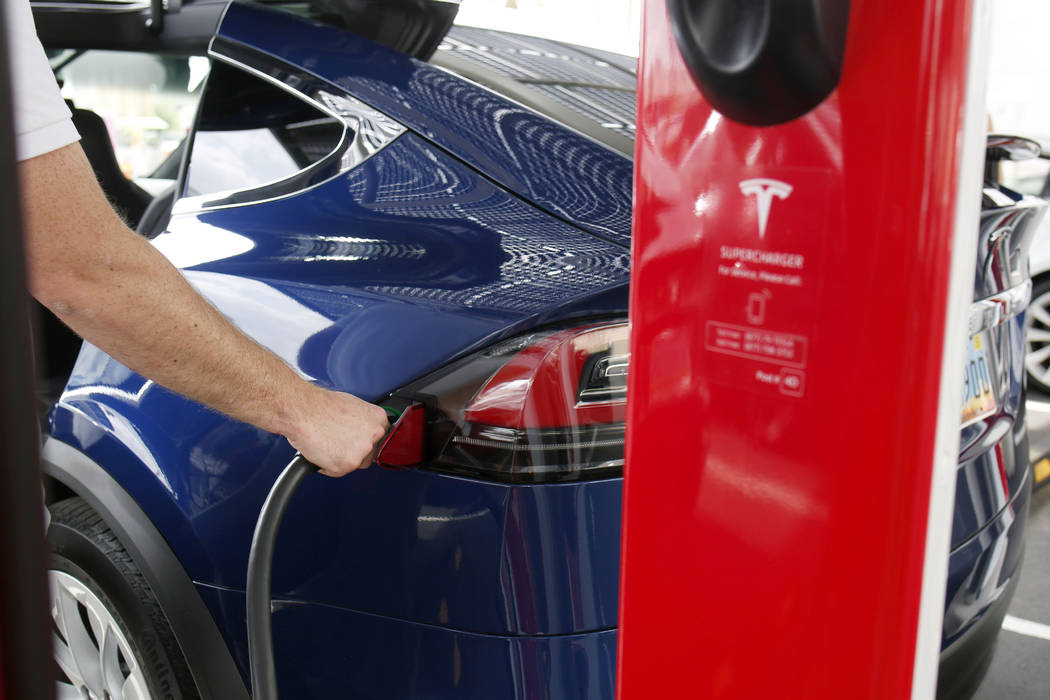 Tesla's Model X is charged at the largest Tesla Supercharger station now open near the High Rol ...