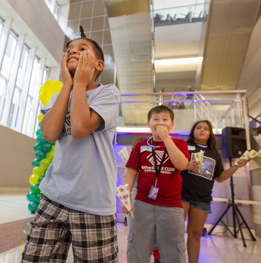 Jaime Rodriguez, 9, looks in shock, as his paper plane becomes stuck by a mirror, as Connor Par ...