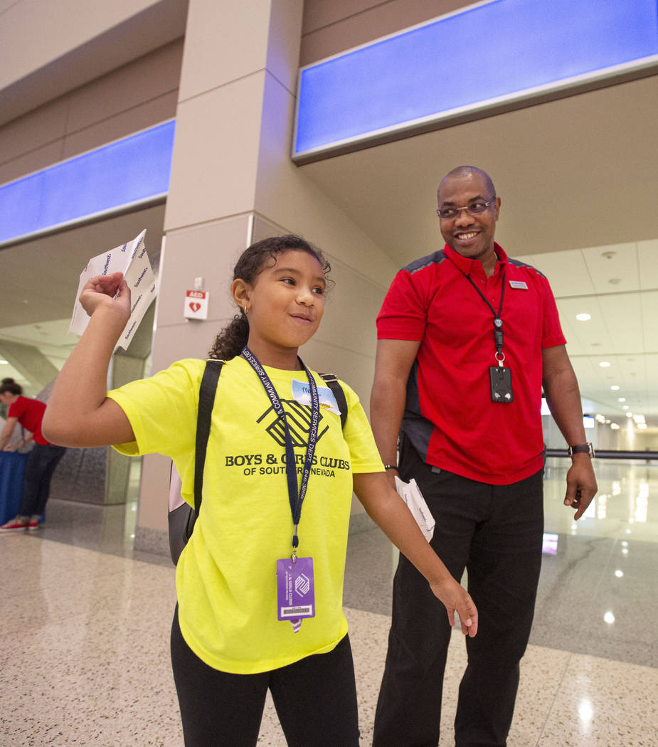 Malia English, 8, practices paper plane throwing with volunteer Frederick Kuforiji during the s ...