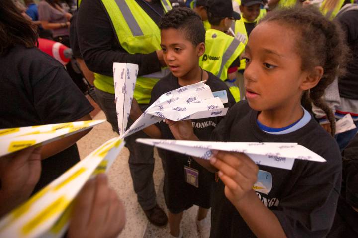 Teammates Adrian Bautista, 7, left, and Shanti Stanley, 7, right, look at the sizes of their pa ...