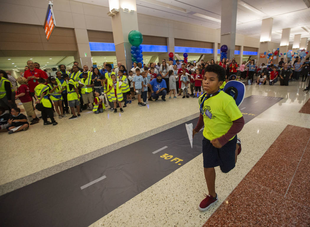 Anwuan Ferguson, 12, runs to his starting point, during the seventh annual Paper Plane Palooza ...