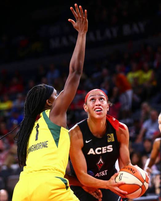 Las Vegas Aces' Dearica Hamby looks to shoot under pressure from Seattle Storm's Crystal Langho ...