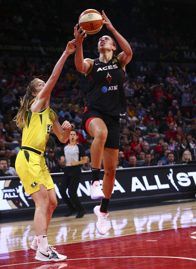 Las Vegas Aces' Dearica Hamby goes to the basket against Seattle Storm's guard Blake Dietrick d ...
