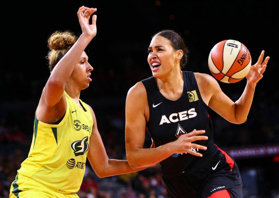 Las Vegas Aces' Liz Cambage moves the ball against Seattle Storm's Mercedes Russell during the ...