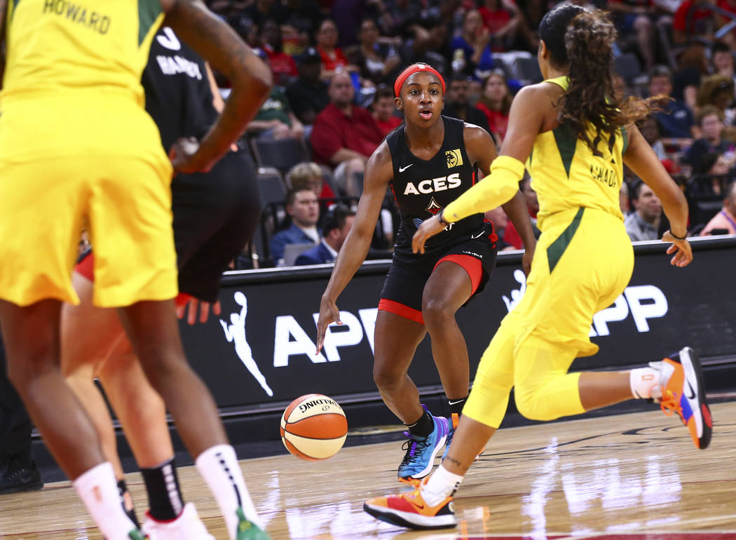 Las Vegas Aces' Jackie Young brings the ball up court against the Seattle Storm during the seco ...