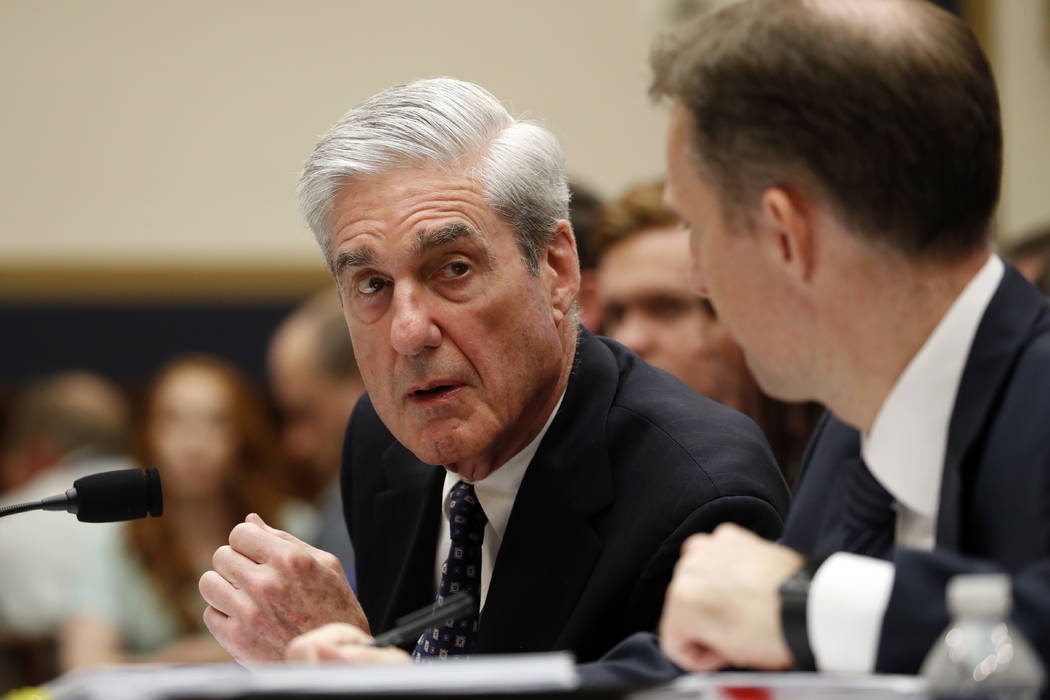 Former special counsel Robert Mueller, accompanied by his top aide in the investigation Aaron Z ...