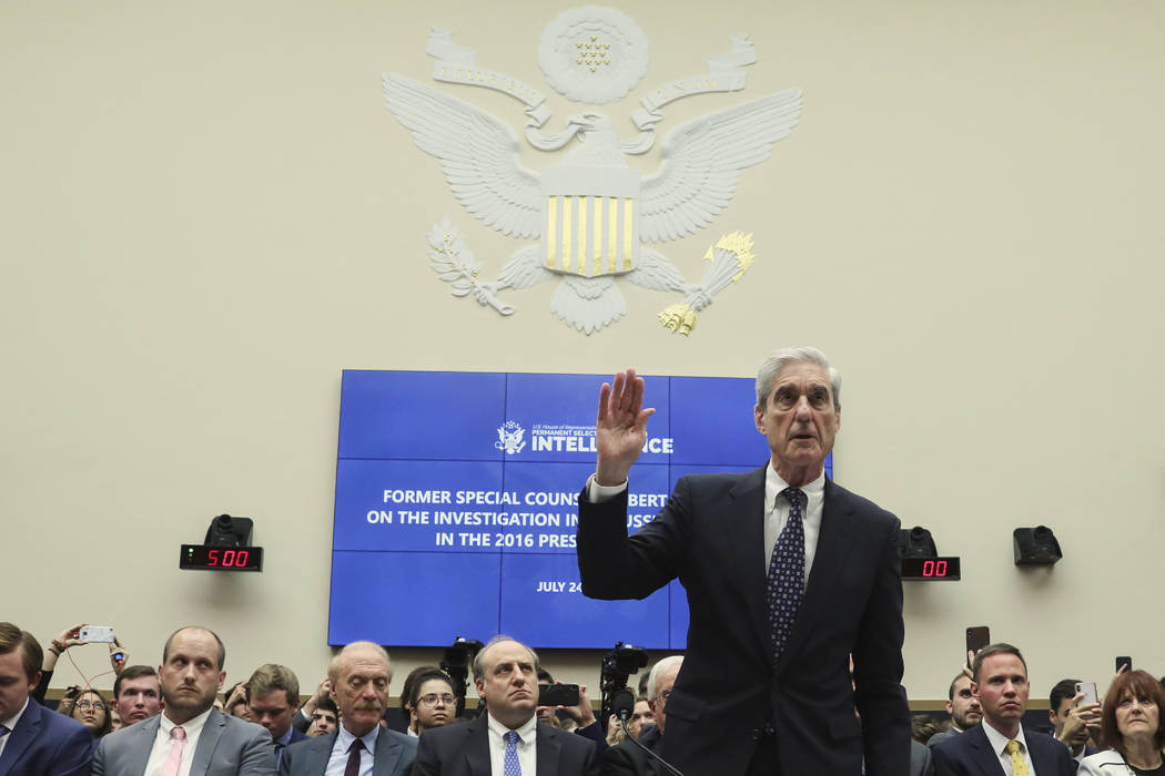 Former special counsel Robert Mueller is sworn in to testify before a House Intelligence Commit ...