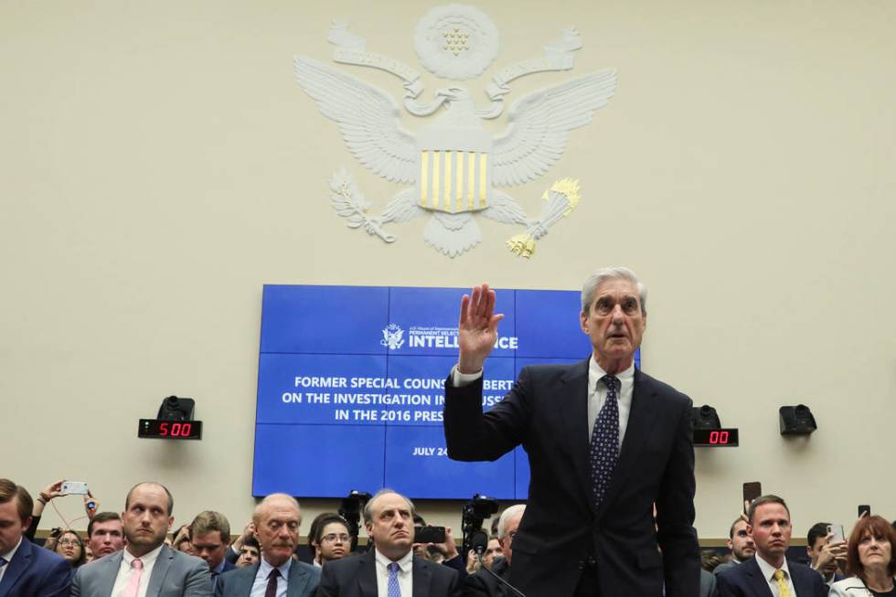 Former special counsel Robert Mueller is sworn in to testify before a House Intelligence Commit ...