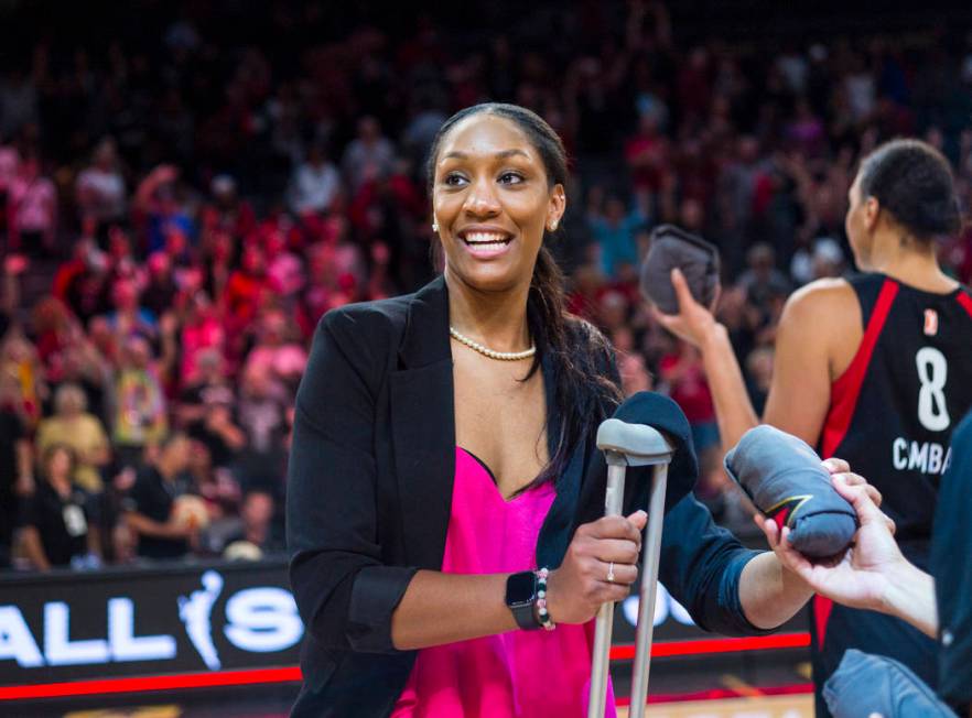 Las Vegas Aces' A'ja Wilson looks to throw t-shirts to the crowd after a WNBA basketball game a ...