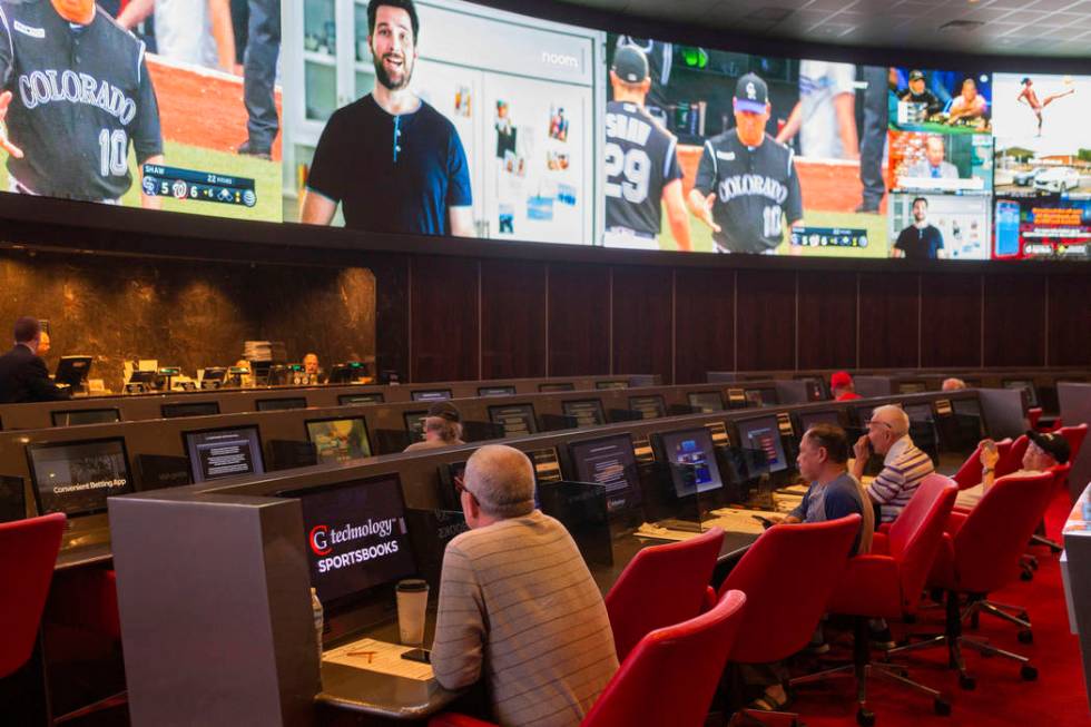 Bettors watch live sports at the CG Technology sportsbook at the Palms in Las Vegas, Thursday, ...