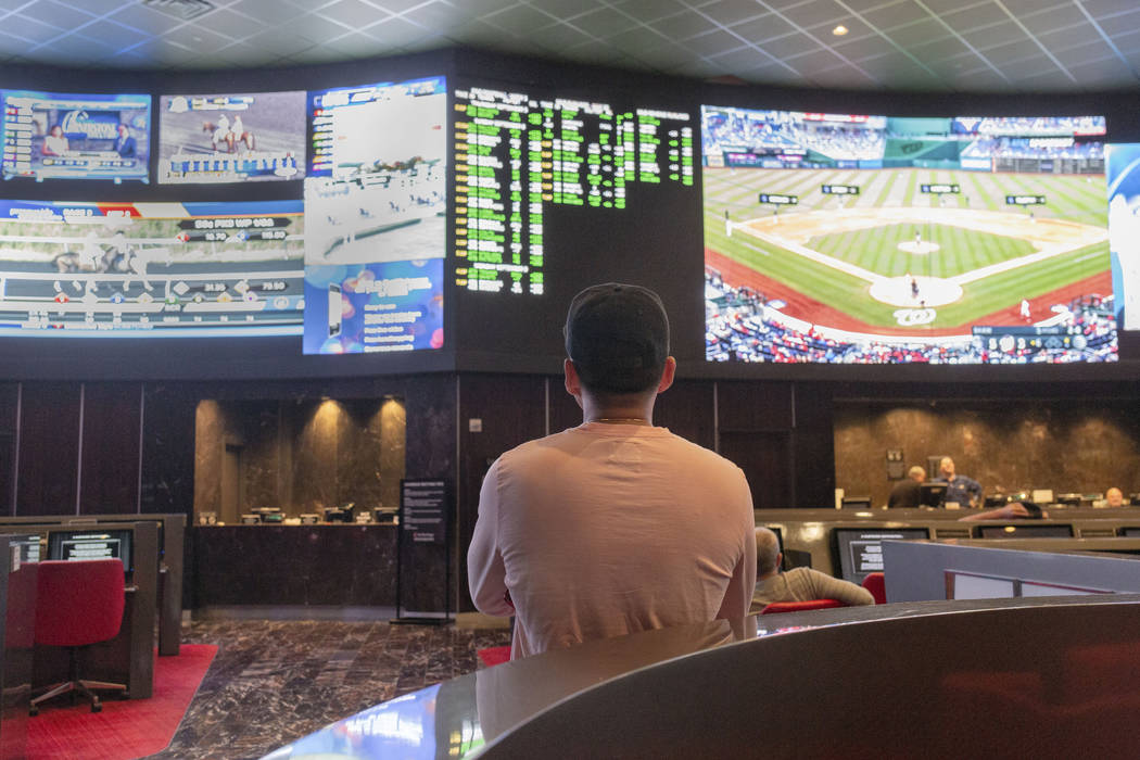 Bettors watch live sports at the CG Technology sportsbook at the Palms in Las Vegas, Thursday, ...