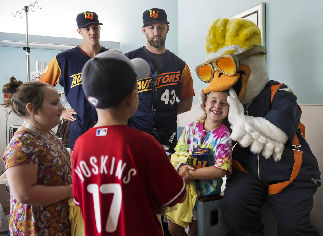 Las Vegas Aviators mascot Spruce the Goose, right, jokes around with Rylee Bannister,8, second ...