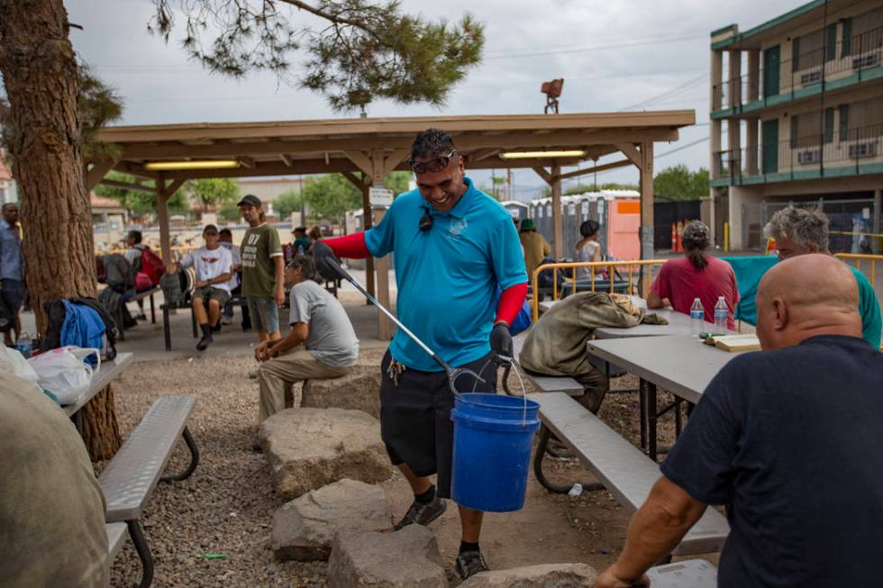 Harlan Thompson picks up trash at the Courtyard Homeless Resource Center in Las Vegas, Thursday ...