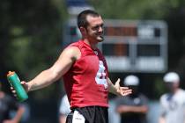 Oakland Raiders quarterback Derek Carr (4) takes a water break during warm ups at mandatory min ...