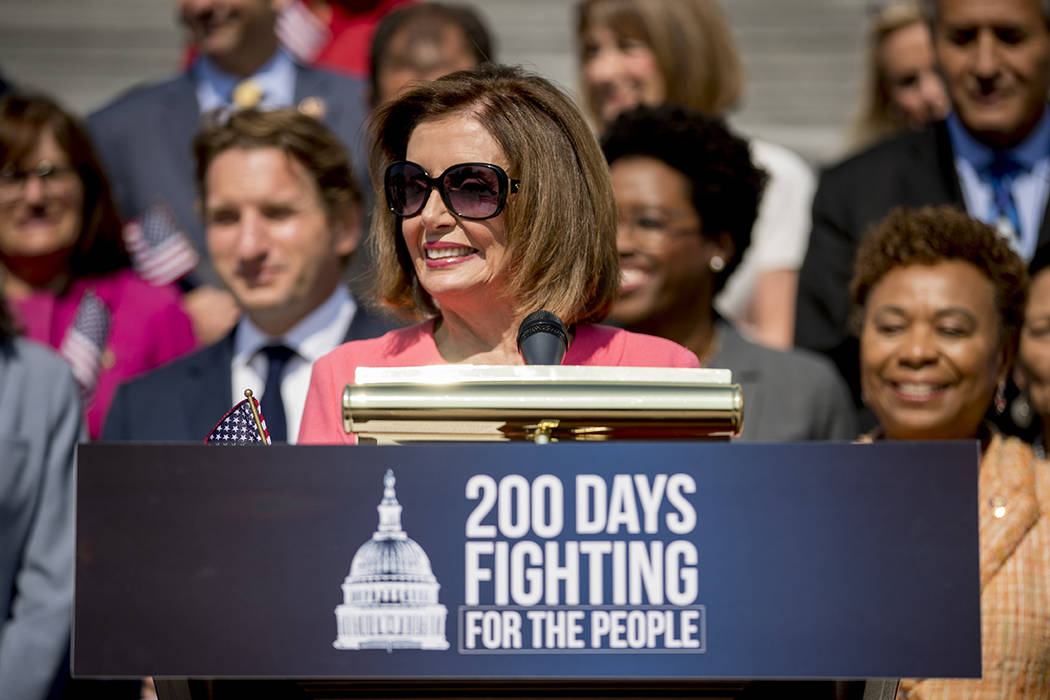 House Speaker Nancy Pelosi of Calif. and House Democrats smiles as she speaks at a news confere ...