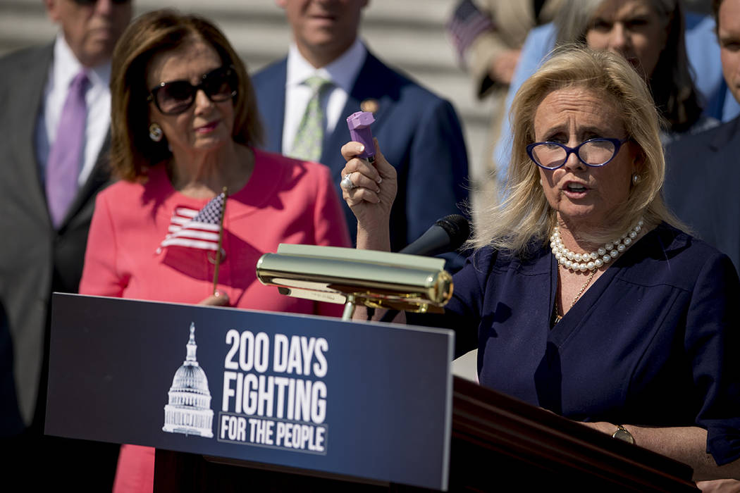 Rep. Debbie Dingell, D-Mich., right, accompanied by House Speaker Nancy Pelosi of Calif., left, ...