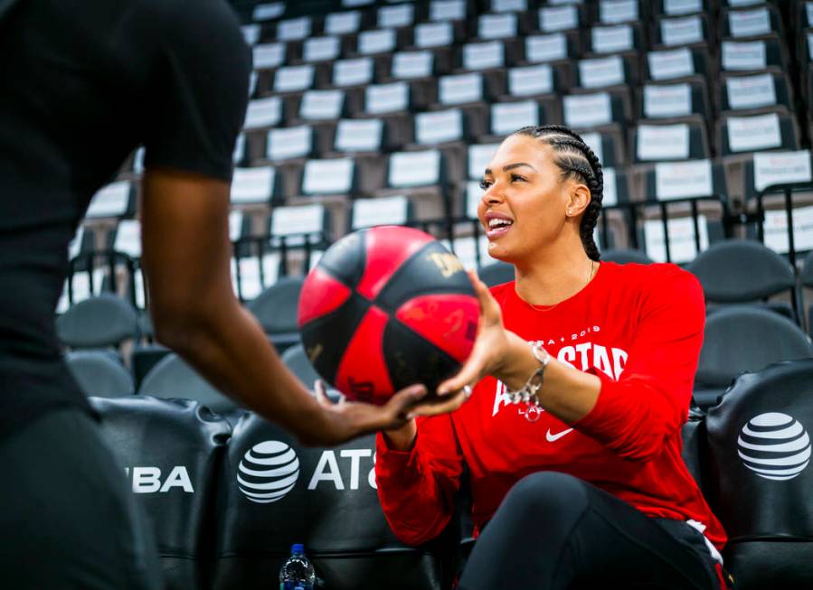 Las Vegas Aces' Liz Cambage hands a signed ball over ahead of the WNBA All-Star Game and skills ...