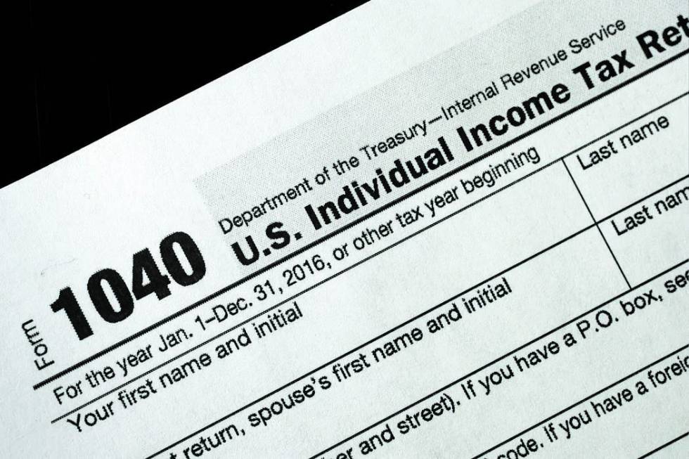 A 1040 tax form appears on display, Tuesday, Jan. 10, 2017, in New York. (AP Photo/Mark Lennihan)