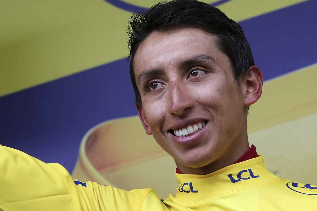 Colombia's Egan Bernal wearing the overall leader's yellow jersey celebrates on the podium afte ...