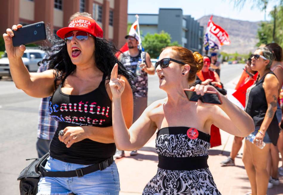 Counter protester Jennifer Harrison, left, with the AZ Patriots group, live-streams as Tamara T ...