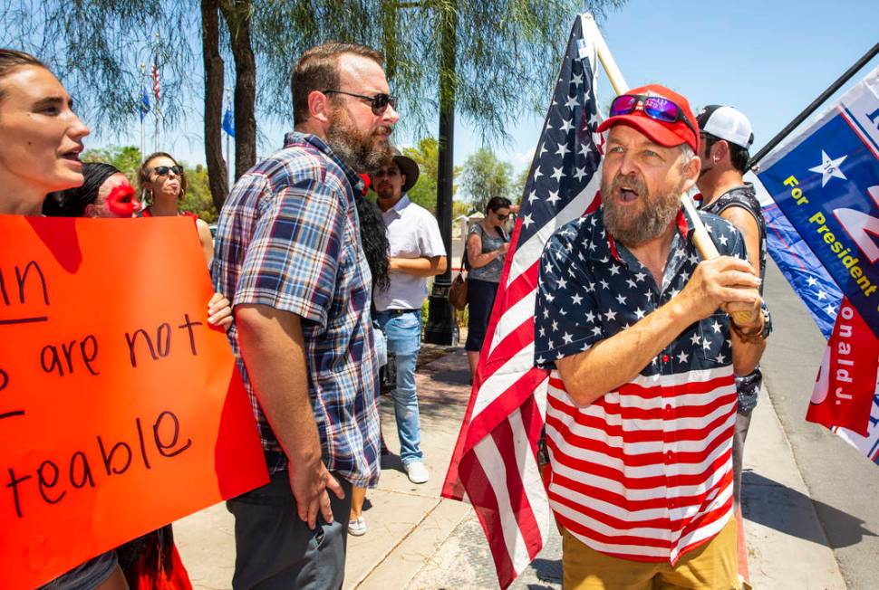 Counter protester John Eakins, right, yells some adversarial comments back to protestors Dylan ...