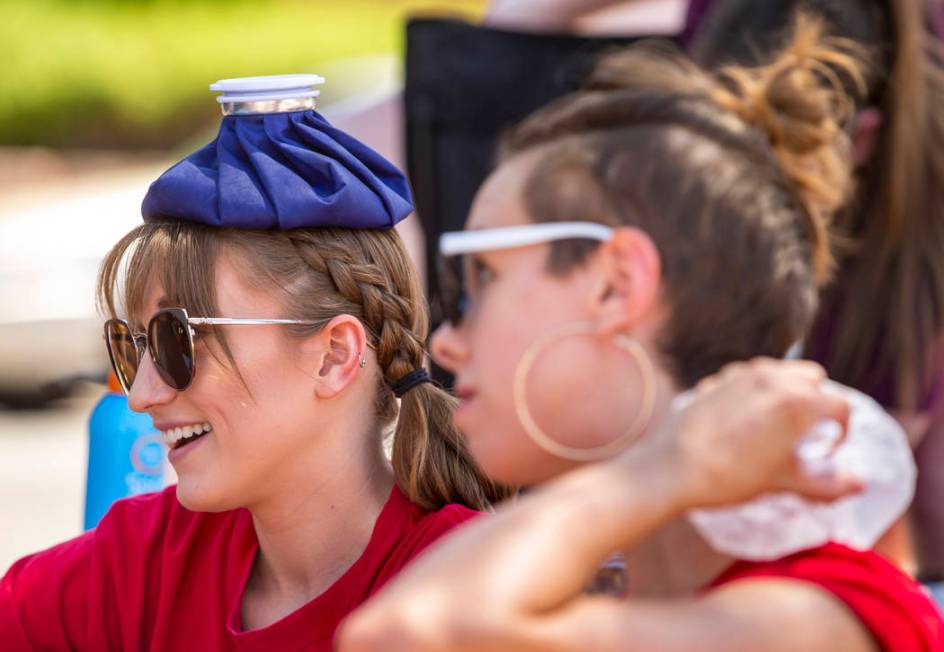 Protesters Taylor Abell, left, and Rachel Siota attempt to stay cool at the Red Rage Protest fo ...