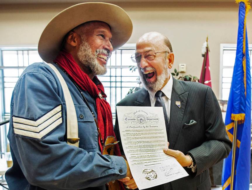 Keith Hill, president trooper of the 9th and 10th Horse Cavalry Association, shakes the hand of ...