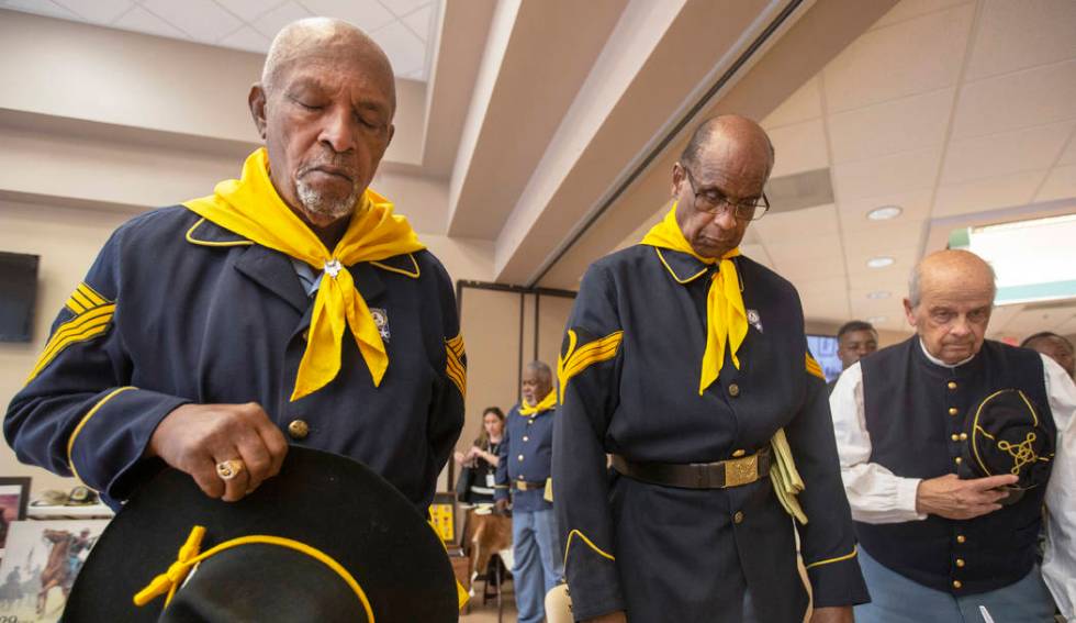 Buffalo Soldier members William Crenshaw, left, Ollie Henry and Fred Hampton pray during Buffal ...