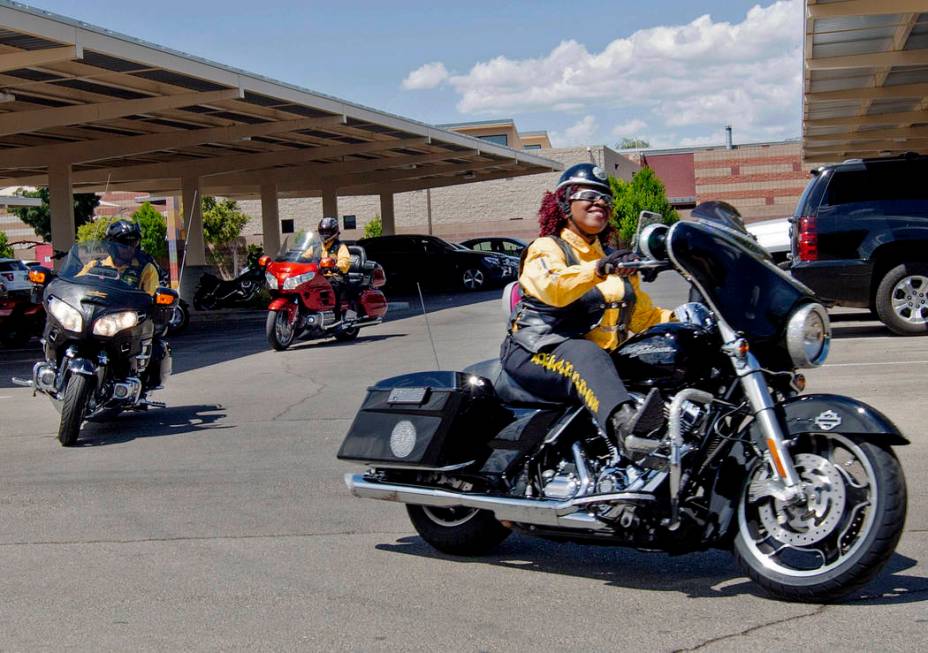 Buffalo Soldiers motorcyclist Judy Ann Young, right, pulls into Doolittle Senior Center for Buf ...