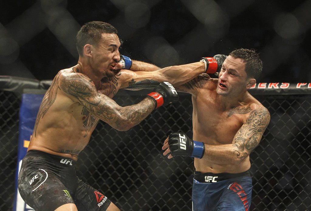 Max Holloway, left, and Frankie Edgar connect on each other during a mixed martial arts bout a ...