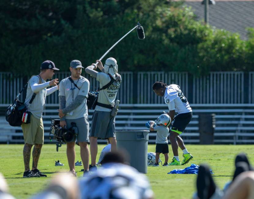 Oakland Raiders wide receiver Antonio Brown (84) plays on the sideline with his sons as he is f ...