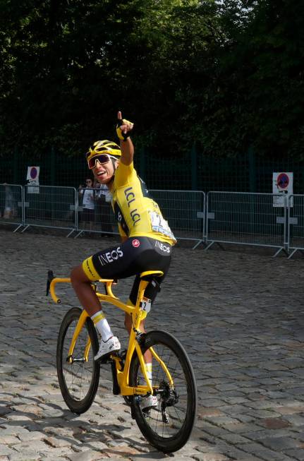 Colombia's Egan Bernal wearing the overall leader's yellow jersey waves as he arrives for the s ...