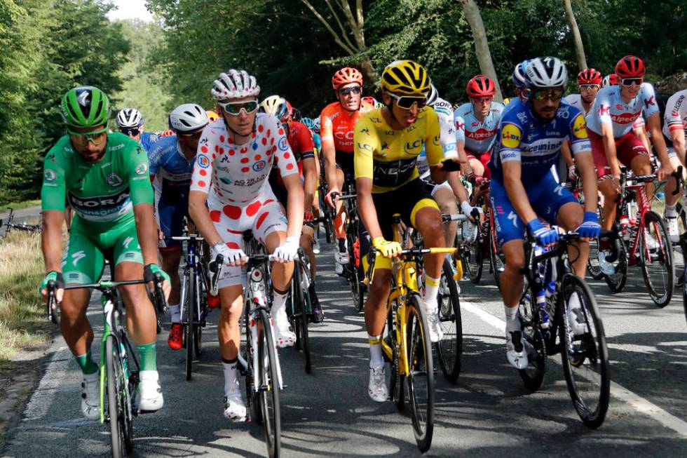 Colombia's Egan Bernal wearing the overall leader's yellow jersey, France's Romain Bardet weari ...