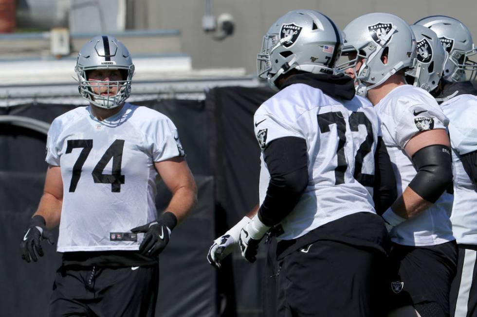 Oakland Raiders offensive tackle Kolton Miller (74) runs toward his fellow offensive linemen du ...