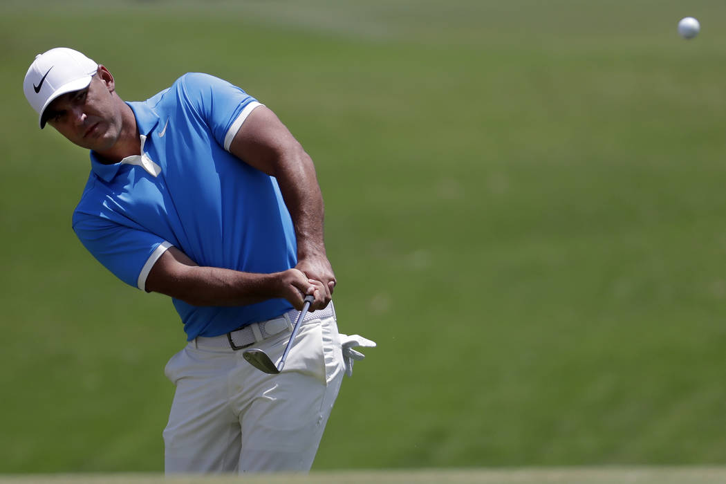 Brooks Koepka chips to the second green during the final round of the World Golf Championships- ...