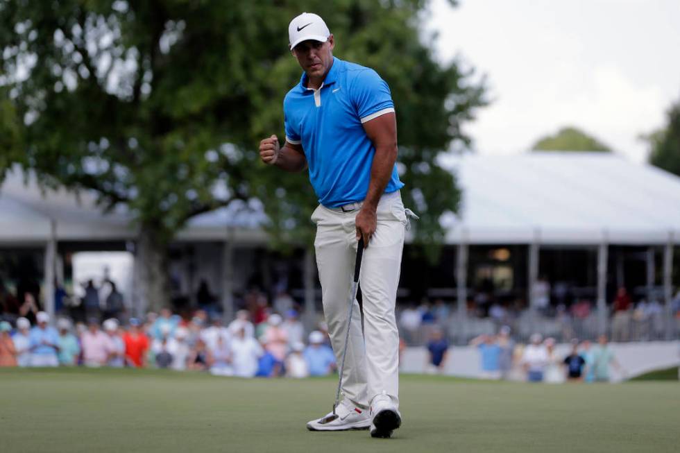 Brooks Koepka celebrates a birdie putt on the 17th green during the final round of the World Go ...