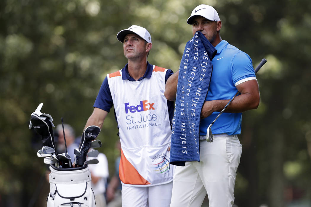 Brooks Koepka prepares to hit on the third fairway during the final round of the World Golf Cha ...