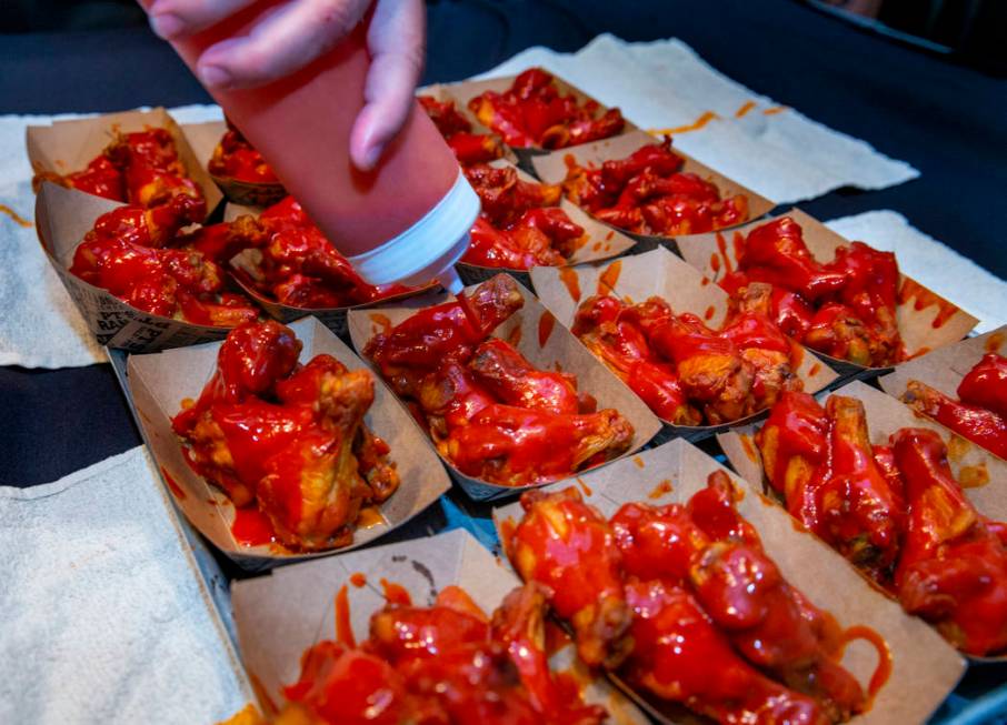 More sauce is poured on a new batch of wings as PT's Ranch hosts a $4,000 wing-eating challenge ...