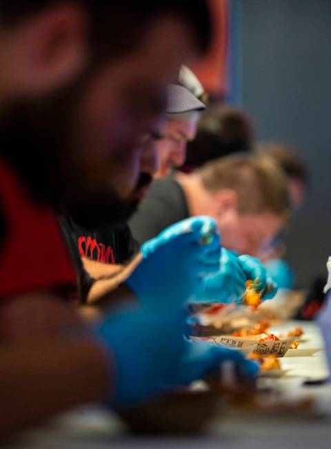 Competitors dig in during their round as PT's Ranch hosts a $4,000 wing-eating challenge on Sun ...