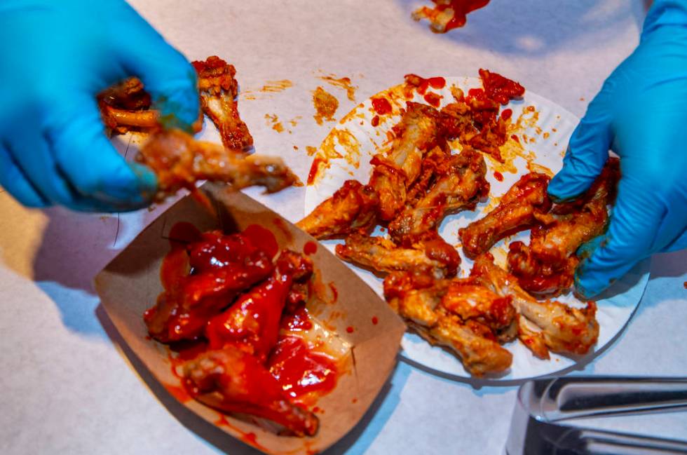 Eaten wings are counted by a judge as PT's Ranch hosts a $4,000 wing-eating challenge on Sunday ...