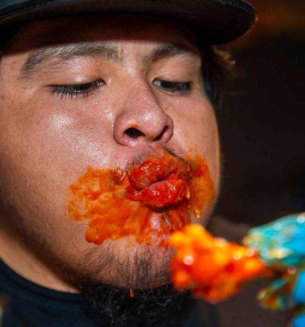 Competitor Alejandro Pascacio feels the sauce burn while eyeing another wing as PT's Ranch host ...