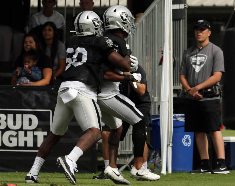 Oakland Raiders linebacker Nicholas Morrow (50) tacklse inside linebacker Brandon Marshall (54) ...