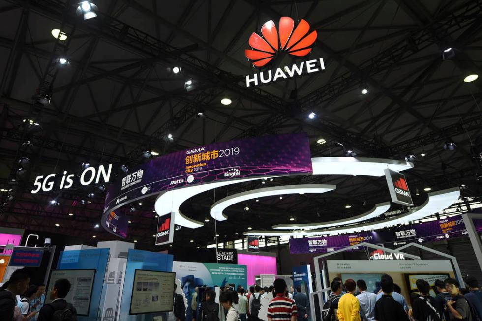 In this June 27, 2019, photo, visitors tour the Huawei pavilion at the Mobile World Congress in ...