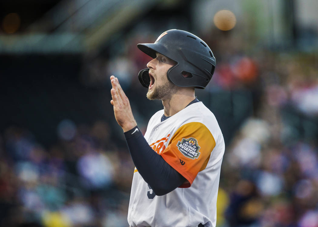 Las Vegas Aviators first baseman Seth Brown (9) signals back to his teammates after singling in ...