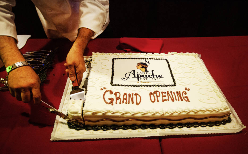 A piece of cake is cut celebrating the grand opening of the Hotel Apache at Binion's on July 2 ...