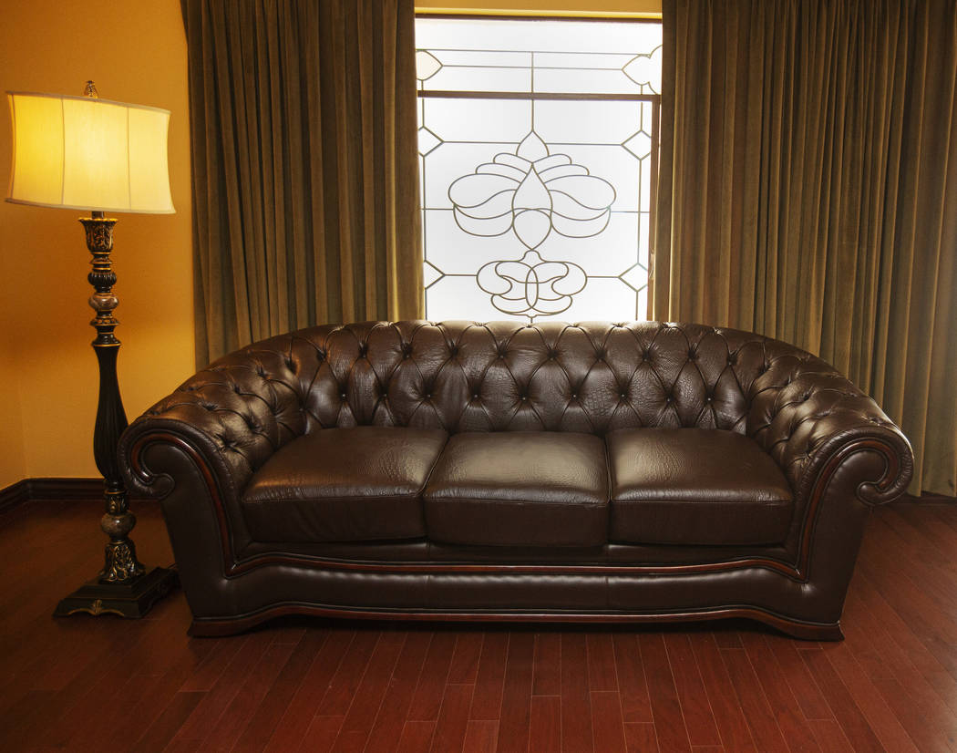 A remodeled lamp and couch of a guest room of the historic Hotel Apache at Binion's Gambling Ha ...
