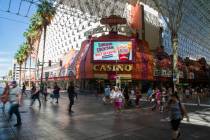 People walk by Fremont, owned by Boyd Gaming Corp., in Las Vegas, Wednesday, June 12, 2019. (Mi ...