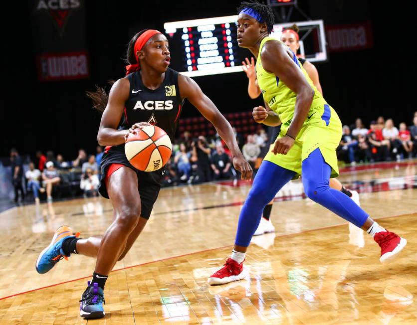 Las Vegas Aces' Jackie Young (0) drives to the basket against Dallas Wings' Kaela Davis (3) dur ...