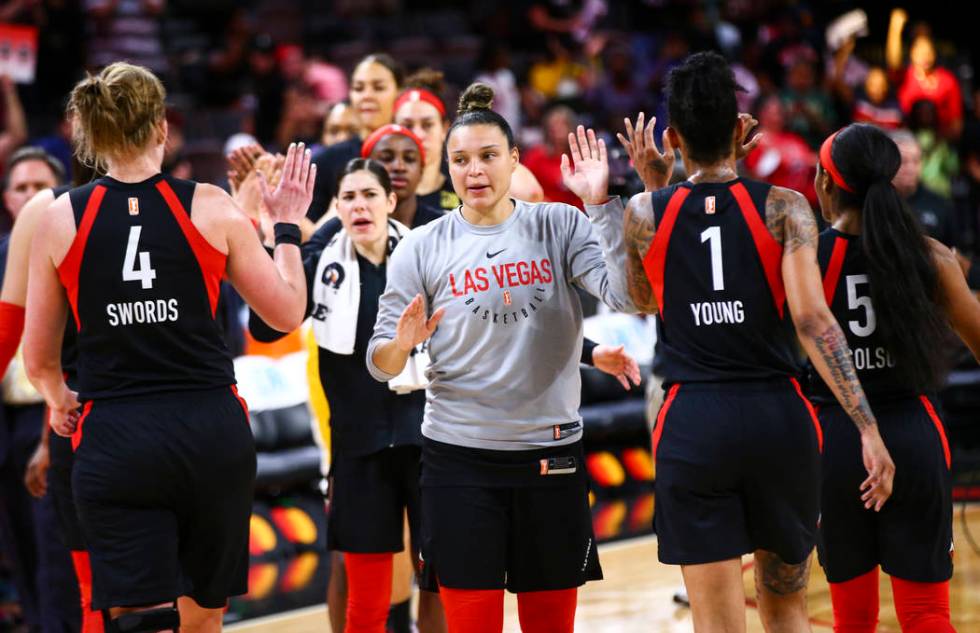 Las Vegas Aces' Kayla McBride, center, celebrates with her team after defeating the Dallas Wing ...