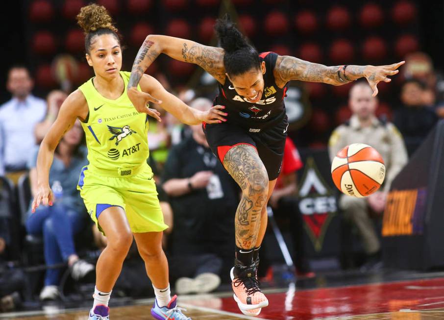 Las Vegas Aces' Tamera Young, right, chases after a loose ball past Dallas Wings' Brooke McCart ...